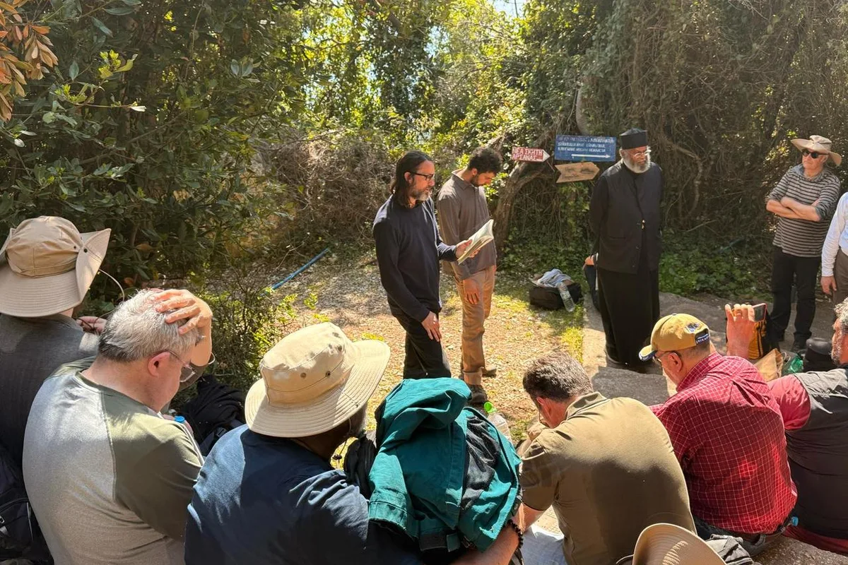 Pilgrims listening to a guide outdoors on Mount Athos